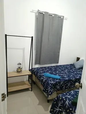 a small bedroom with a bed and a mirror at Casa de Reyes in San Miguel