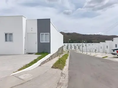 an empty street next to a white building at Casa de Reyes in San Miguel