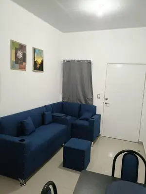 a living room with a blue couch and chairs at Casa de Reyes in San Miguel