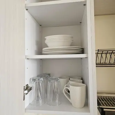 a cupboard filled with dishes and bowls and plates at Apartamento Centrico Colonia Escalón in San Salvador