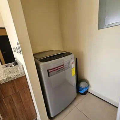 a small refrigerator in a corner of a kitchen at Apartamento Centrico Colonia Escalón in San Salvador