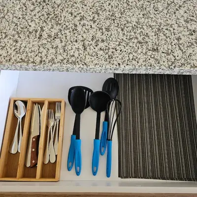 a group of utensils in a drawer under a counter at Apartamento Centrico Colonia Escalón in San Salvador