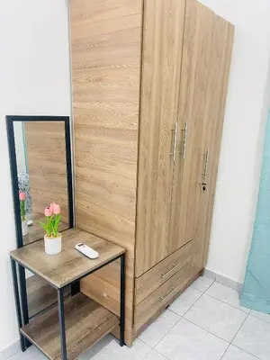 a wooden cabinet with a table and a mirror at Holiday home in San Miguel