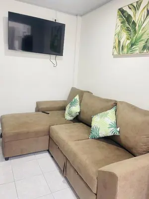 a brown couch in a living room with a flat screen tv at Holiday home in San Miguel