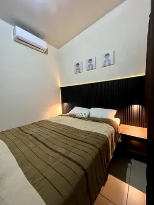 a bedroom with a large bed with a brown blanket at Casa Luz - complete with pool access in Sitio del Niño