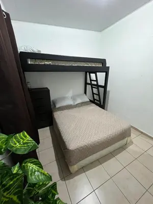 two bunk beds in a room with plants at Casa Luz - complete with pool access in Sitio del Niño