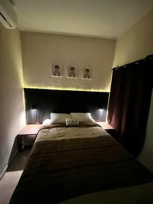 a bedroom with a bed with a light above it at Casa Luz - complete with pool access in Sitio del Niño