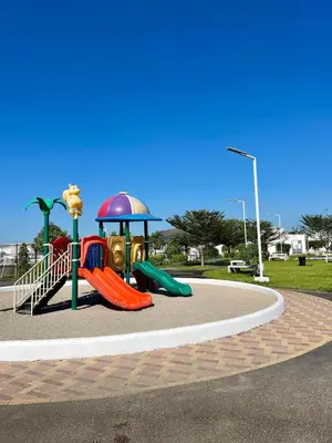 a playground with a slide in a park at Casa Luz - complete with pool access in Sitio del Niño
