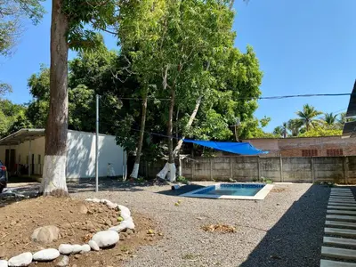 a yard with a swimming pool and a tree at Eco Villa, El Sunzal ISA Surfing in El Sunzal