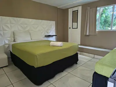 a bedroom with a large bed and a window at Kartagus B&B in San Salvador