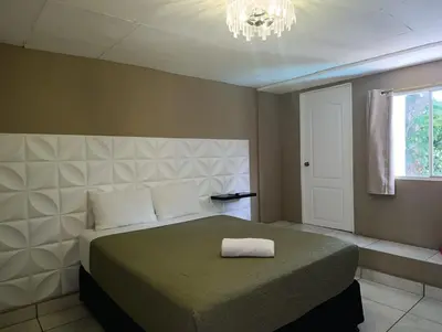 a bedroom with a bed with a towel on it at Kartagus B&B in San Salvador