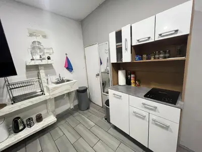 a kitchen with white cabinets and a sink at Smart and Modern Room Full Amenities in San Salvador in San Salvador
