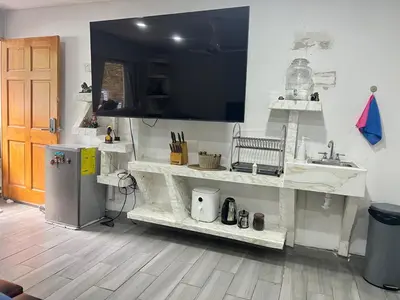 a kitchen with white shelves and a sink at Smart and Modern Room Full Amenities in San Salvador in San Salvador