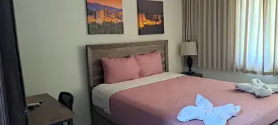 a bedroom with a bed with two towels on it at Kartagus Centric in San Salvador