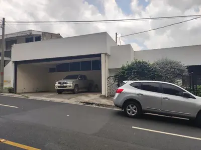 a silver car parked in front of a building at Kartagus Centric in San Salvador