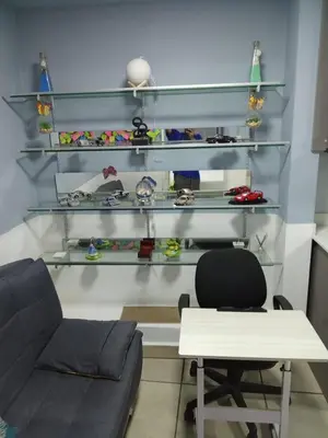 a room with a couch and a table and shelves at Pearl of the sea in La Libertad