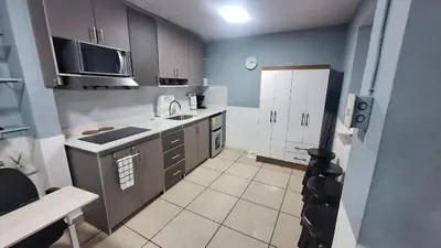 a small kitchen with a sink and a microwave at Pearl of the sea in La Libertad