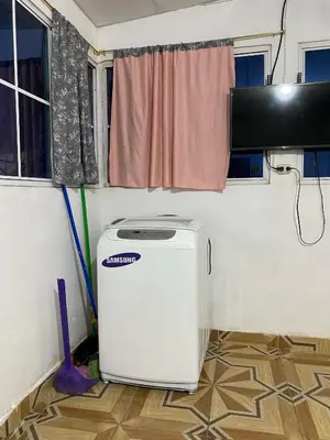 a laundry room with a washer and dryer in a trailer at Aguiñada's House in El Rosario