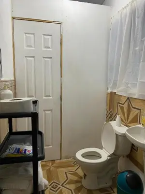 a bathroom with a toilet and a sink at Aguiñada's House in El Rosario