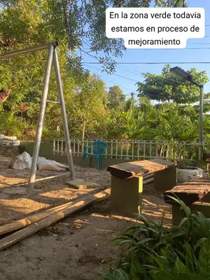a picnic table and a bench in a park at Aguiñada's House in El Rosario