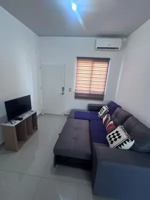 a living room with a blue couch and a television at Nueva San Miguel Miami 703 in San Miguel