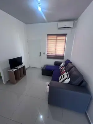 a living room with a blue couch and a television at Nueva San Miguel Miami 703 in San Miguel