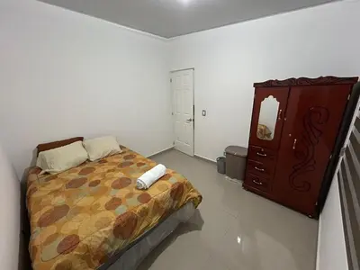 a bedroom with a bed and a dresser at Nueva San Miguel Miami 703 in San Miguel
