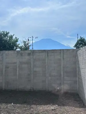 a brick wall with a mountain in the background at Nueva San Miguel Miami 703 in San Miguel