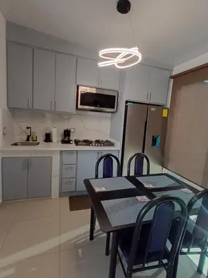 a kitchen with a table and chairs and a refrigerator at Residencial Nueva San Miguel Miami 703 in San Miguel