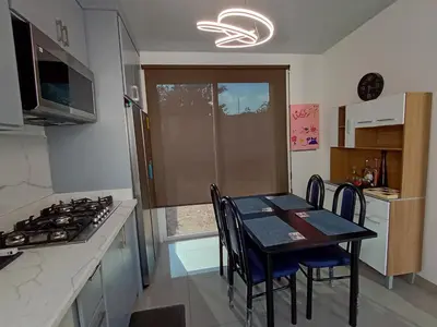 a kitchen with a table with chairs and a stove at Residencial Nueva San Miguel Miami 703 in San Miguel
