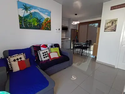 a living room with a blue couch and a table at Residencial Nueva San Miguel Miami 703 in San Miguel