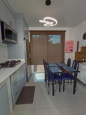 a kitchen with a table and chairs in a room at Residencial Nueva San Miguel Miami 703 in San Miguel