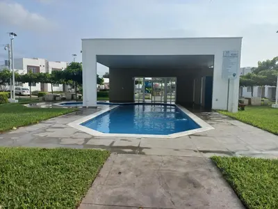 a large swimming pool in a building with a building at Casa Romero in San Miguel
