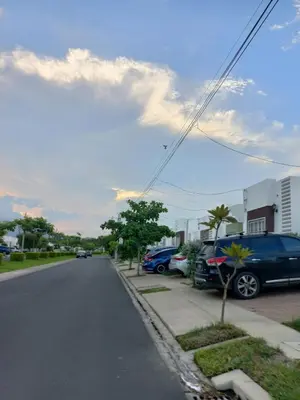 a street with cars parked on the side of the road at Casa Romero in San Miguel