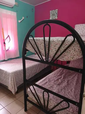 a room with two bunk beds and pink walls at Casa Romero in San Miguel