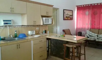 a kitchen with a sink and a counter top at Casa de Playa en residencial las Veraneras San Fer in Los Cóbanos