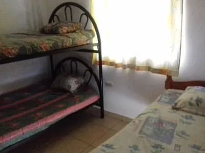 a room with two bunk beds and a window at Casa de Playa en residencial las Veraneras San Fer in Los Cóbanos
