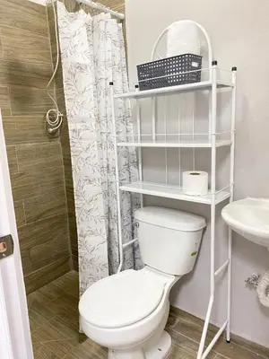 a bathroom with a white toilet and a sink at Apartamento Moderno y Privado in Santa Ana