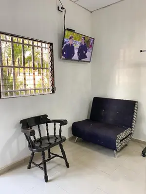 a room with a couch and a chair and a window at Apartamento Moderno y Privado in Santa Ana