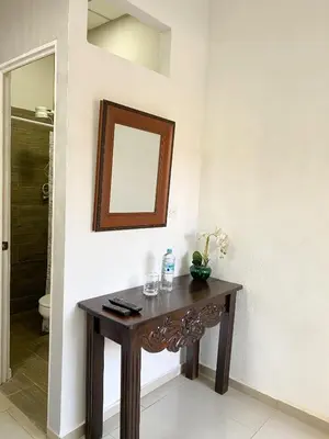 a wooden table in a room with a mirror at Apartamento Moderno y Privado in Santa Ana