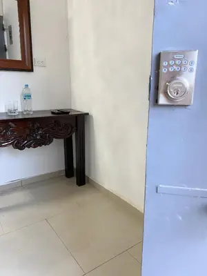 a room with a counter and a table and a refrigerator at Apartamento Moderno y Privado in Santa Ana