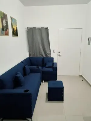 a living room with a blue couch and a door at Casa de Reyes in San Miguel
