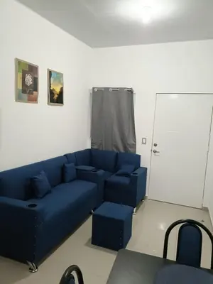 a living room with a blue couch and chairs at Casa de Reyes in San Miguel