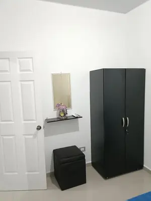 a black cabinet with a stool next to a door at Casa de Reyes in San Miguel