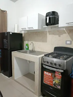 a kitchen with a stove and a sink and a refrigerator at Casa de Reyes in San Miguel