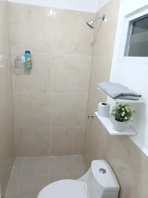 a bathroom with a shower and a white toilet at Casa de Reyes in San Miguel