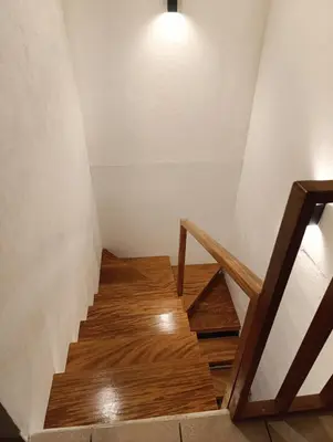 a staircase with a light and wooden floor at Dinos House in Concepción de Ataco