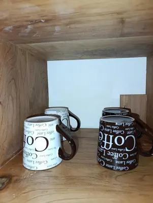 two coffee mugs sitting on top of a wooden shelf at Dinos House in Concepción de Ataco