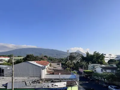 a view of a city with mountains in the background at Ipan Noya in Nueva San Salvador