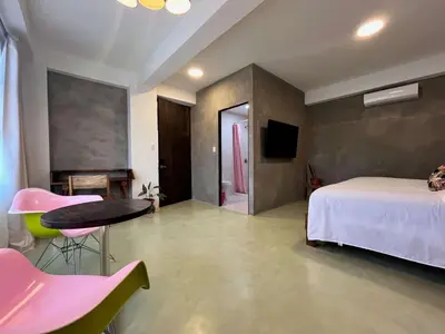 a bedroom with a bed and a table and a tv at Ipan Noya in Nueva San Salvador